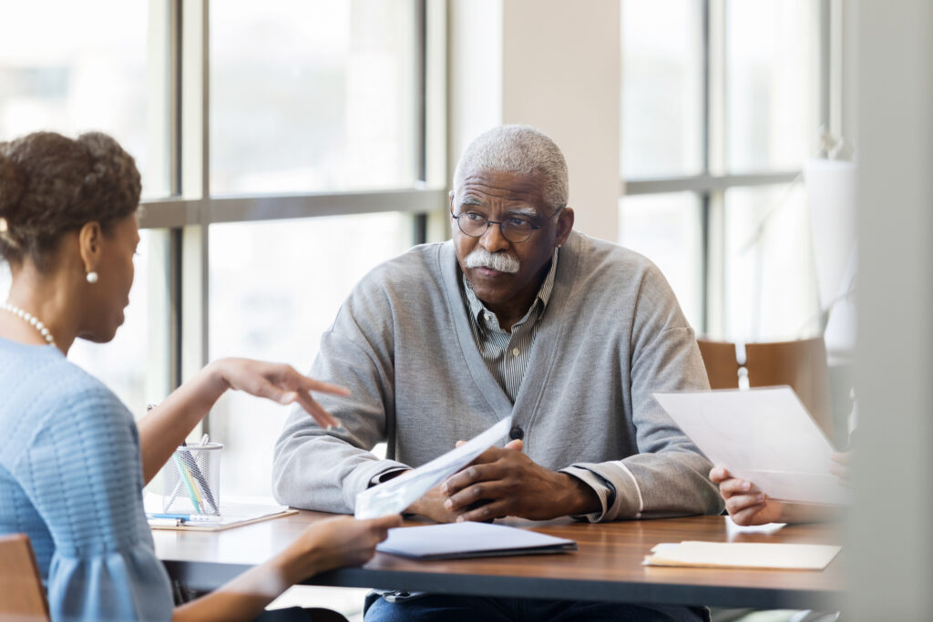 A senior African American man speaking with a loan officer